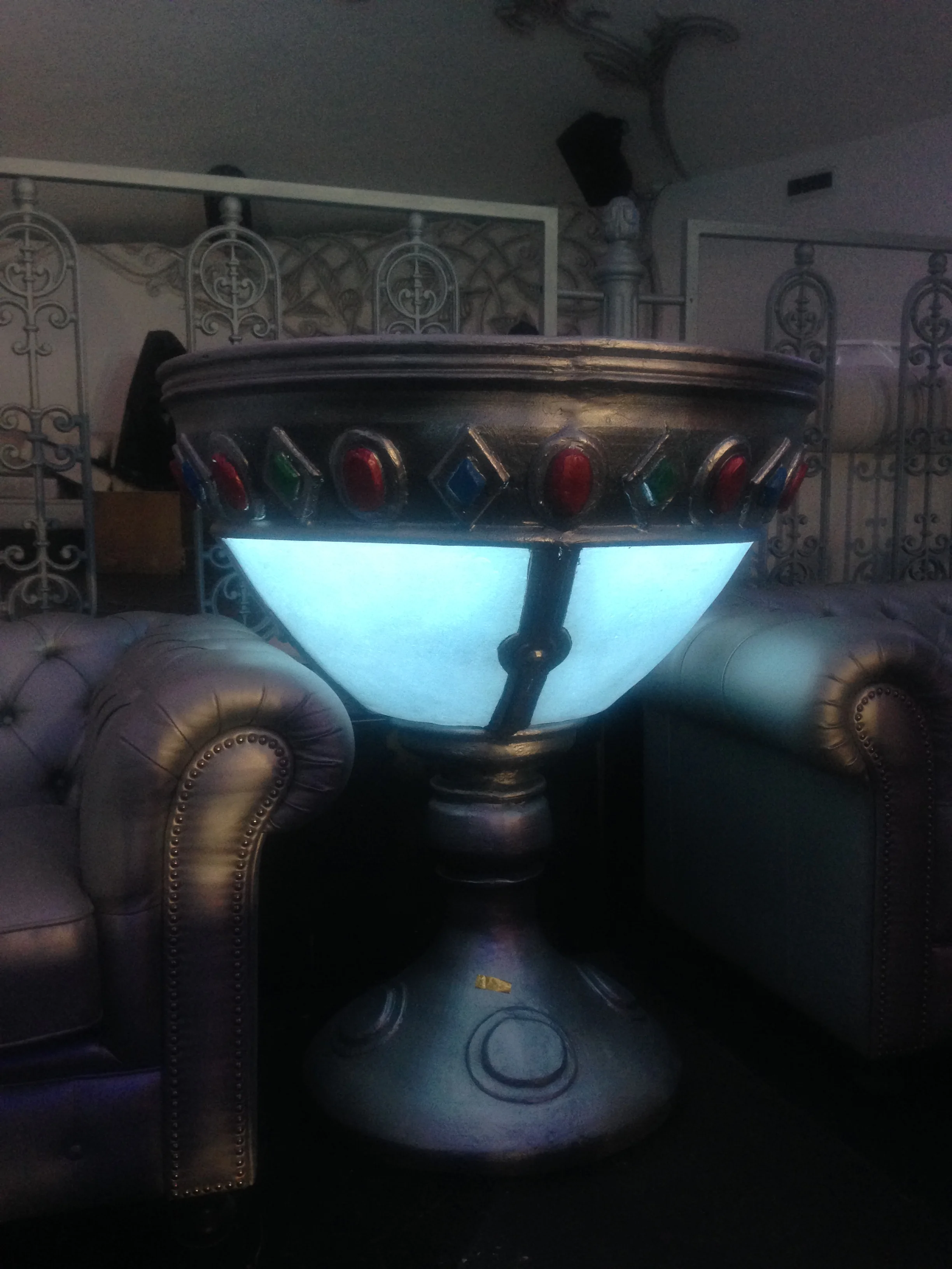 View of the privé lounge at Art Café with the burnished metallic-leather Chesterfield sofas arranged around low tables, our goblets in the background, an intimate exclusive-club atmosphere