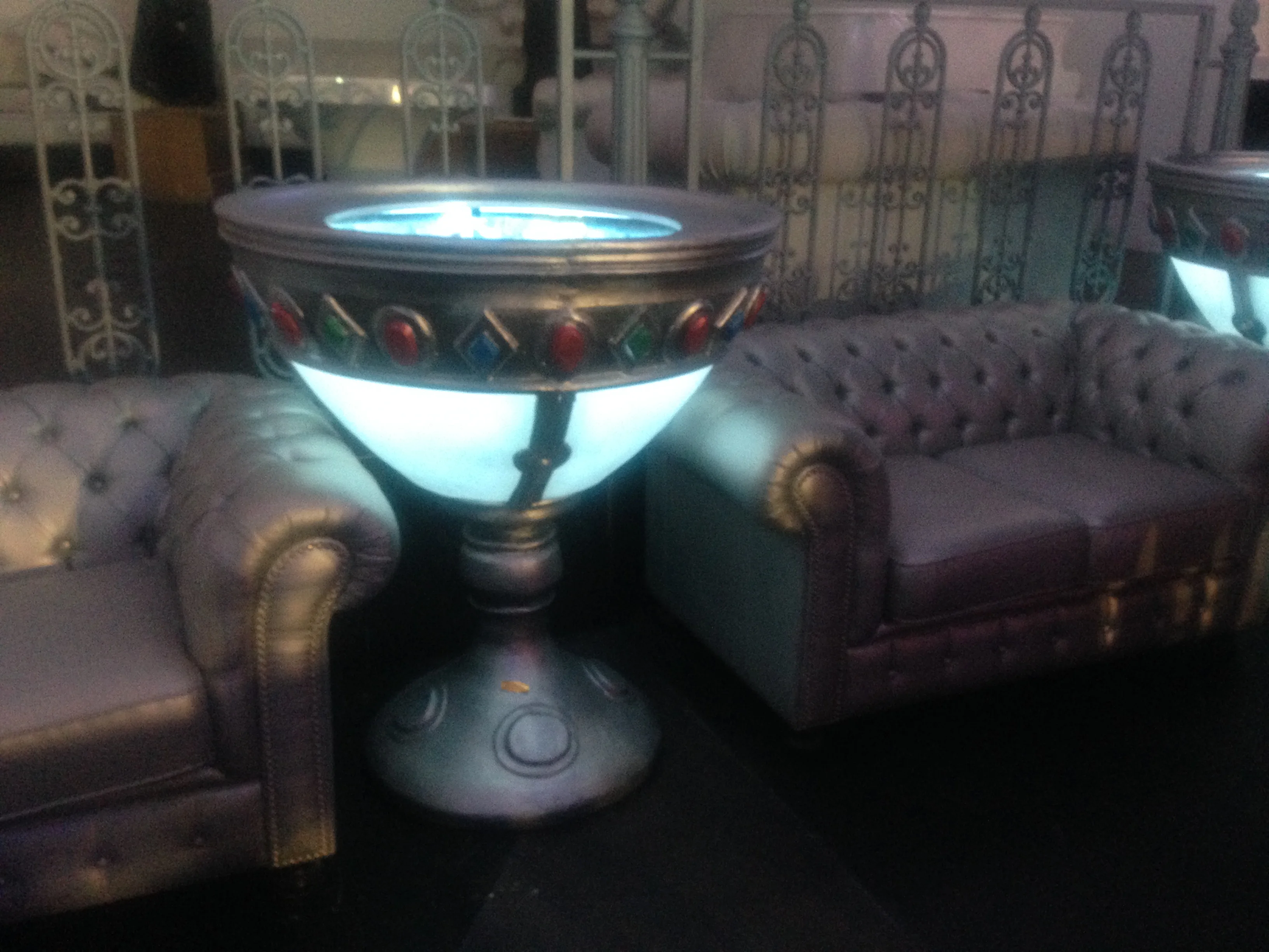 Overview of an area of Art Café with several scenographic goblets laid out like stage scenography: wide perspective of the underground lounge, metallic decorations of the venue, atmosphere of Roman nightlife