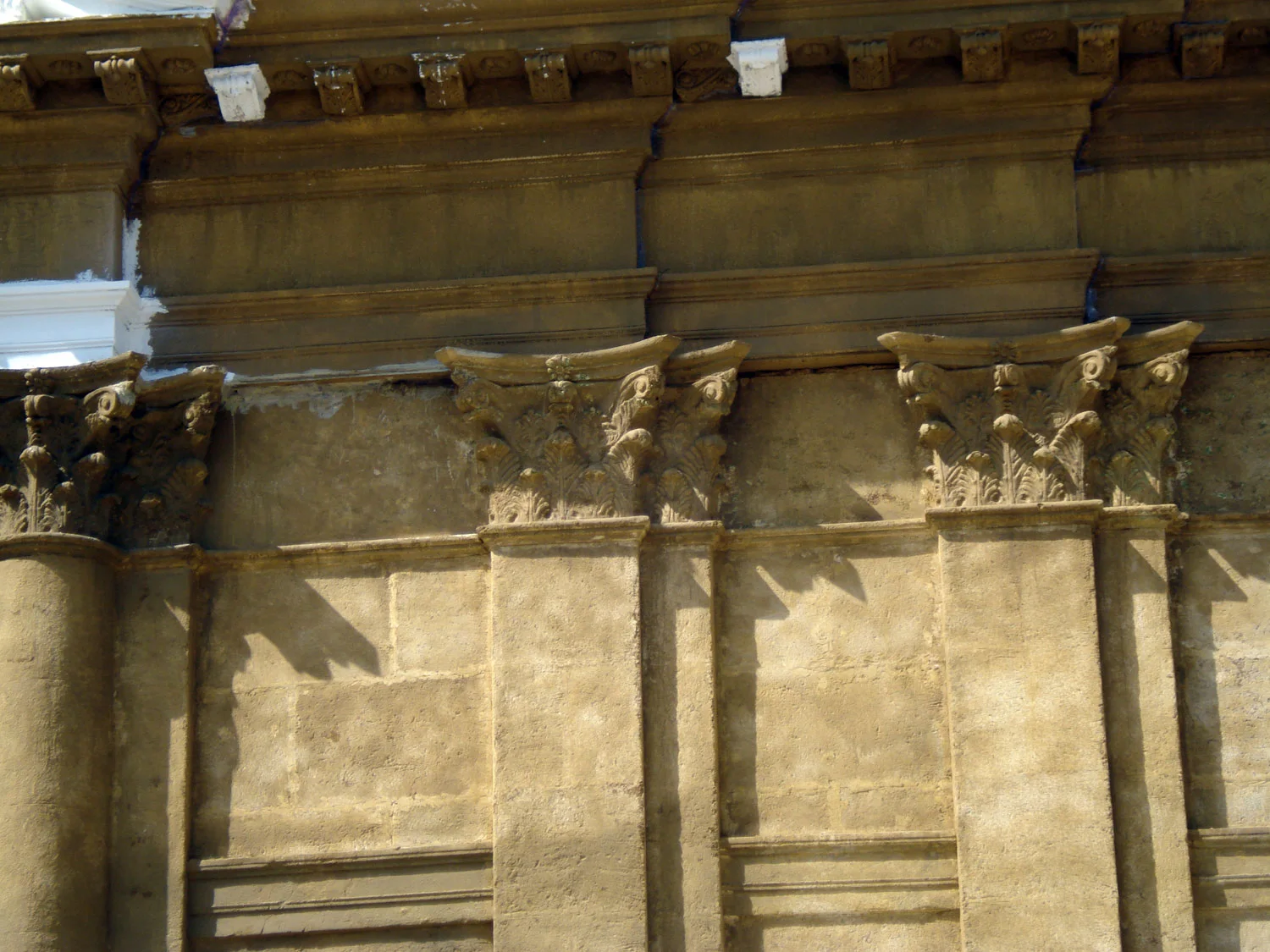 The square of Bagheria completed, deserted before filming: nineteenth-century facades with balustrades, perspective onto the monumental gateway at the far end of the street.