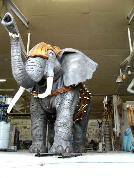 Life-size sculpted elephant with golden helmet and armor