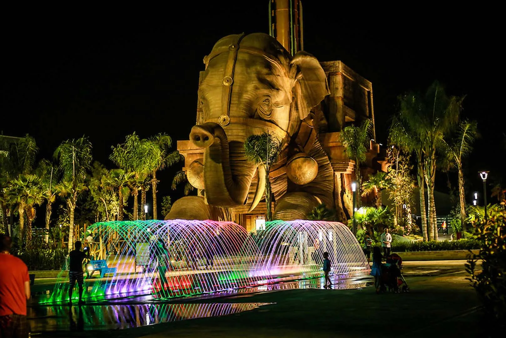 Indiana Adventure elephant at night in the park with illuminated fountains and visitors