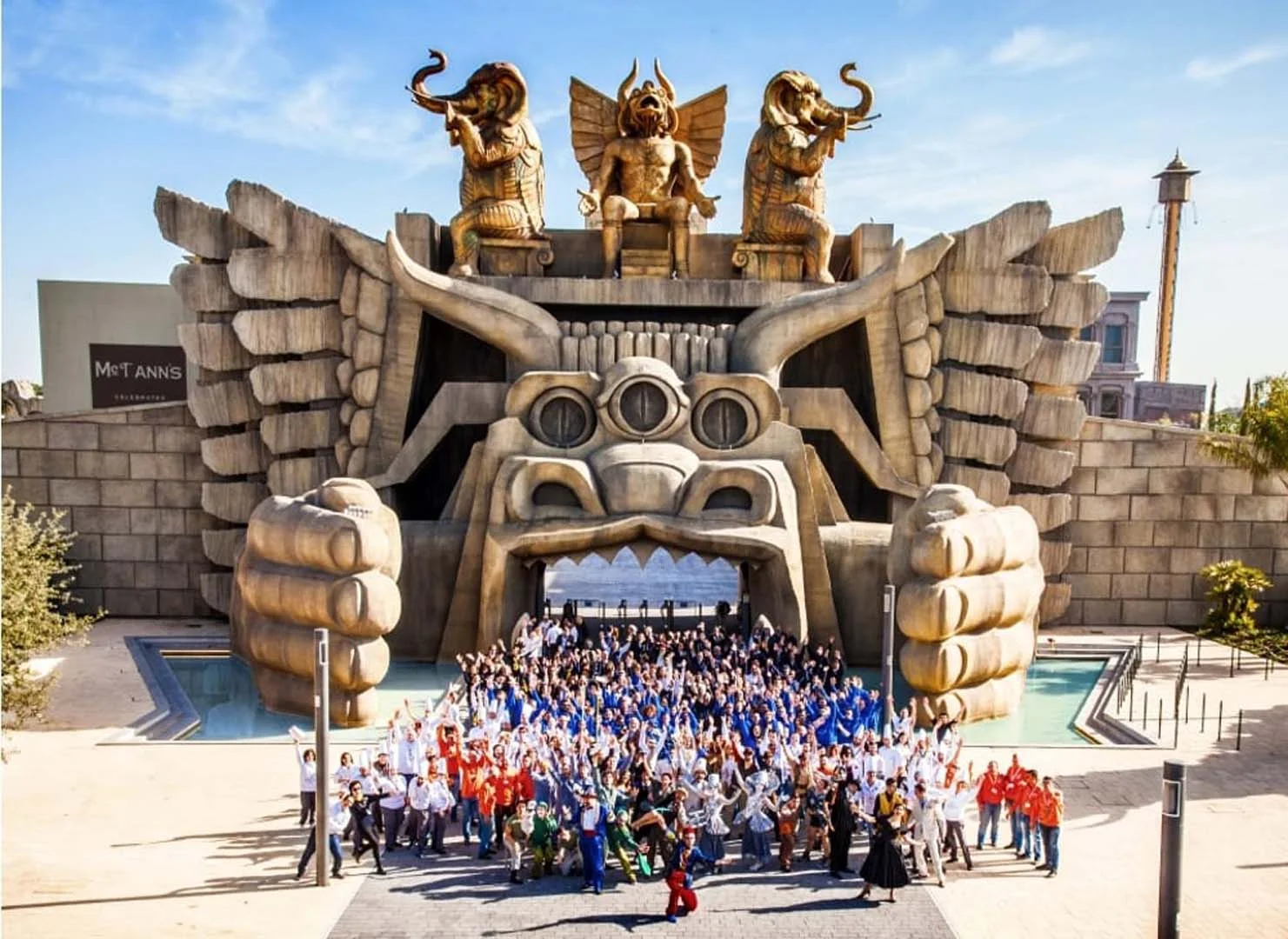 The Cabiria entrance gate photographed in daylight with visitors and staff in front, monumental entrance arch at full scale