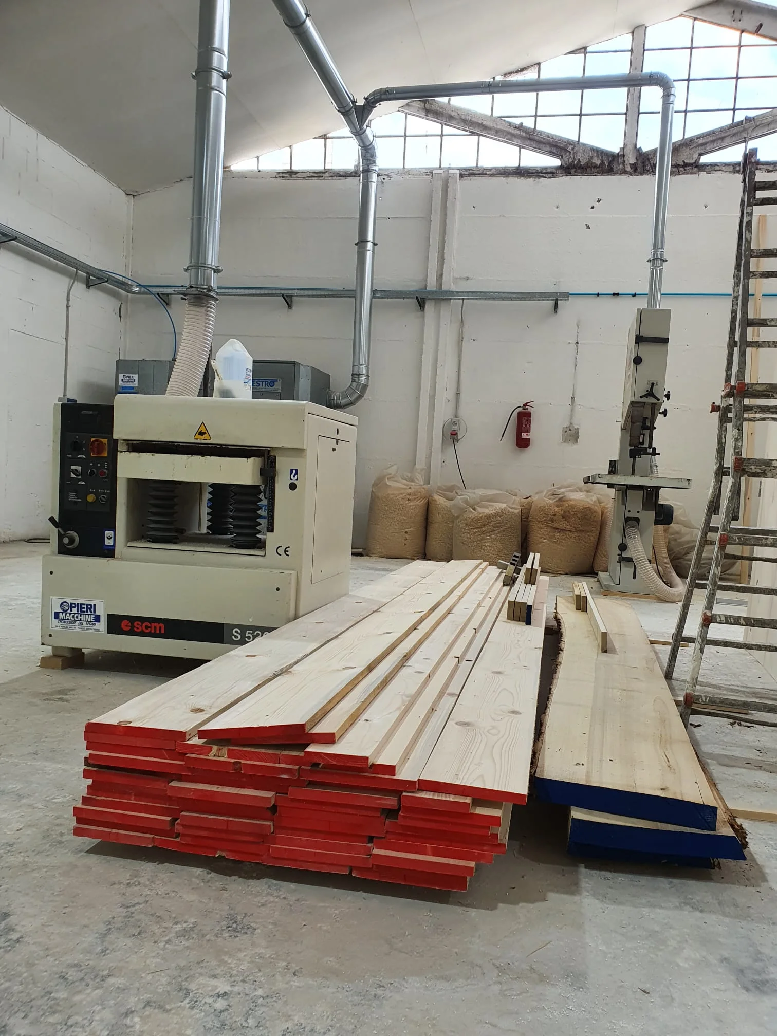 Carpentry workbench with cutting equipment and timber pieces in progress