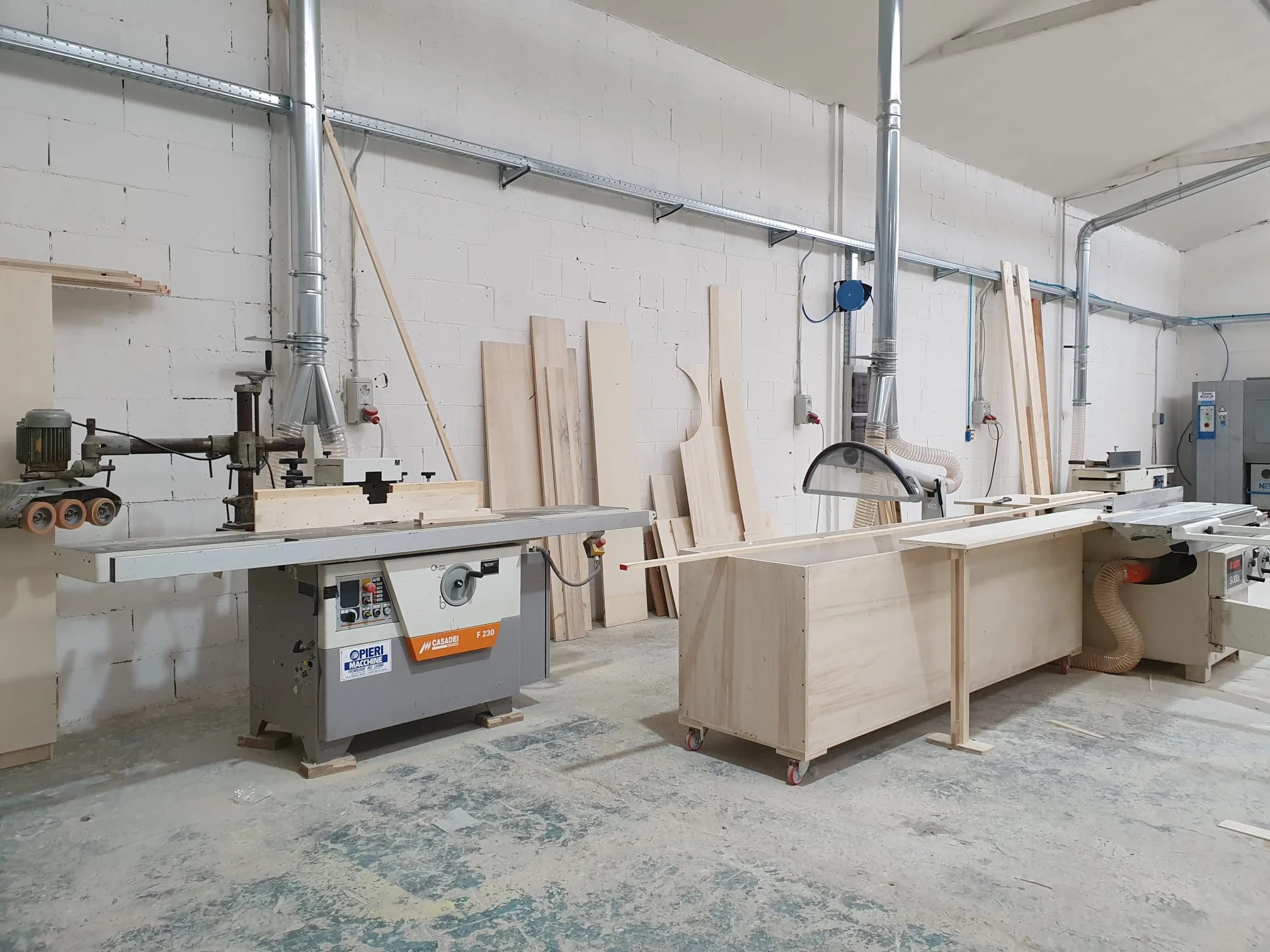 Milling bench in the carpentry workshop with panel being worked