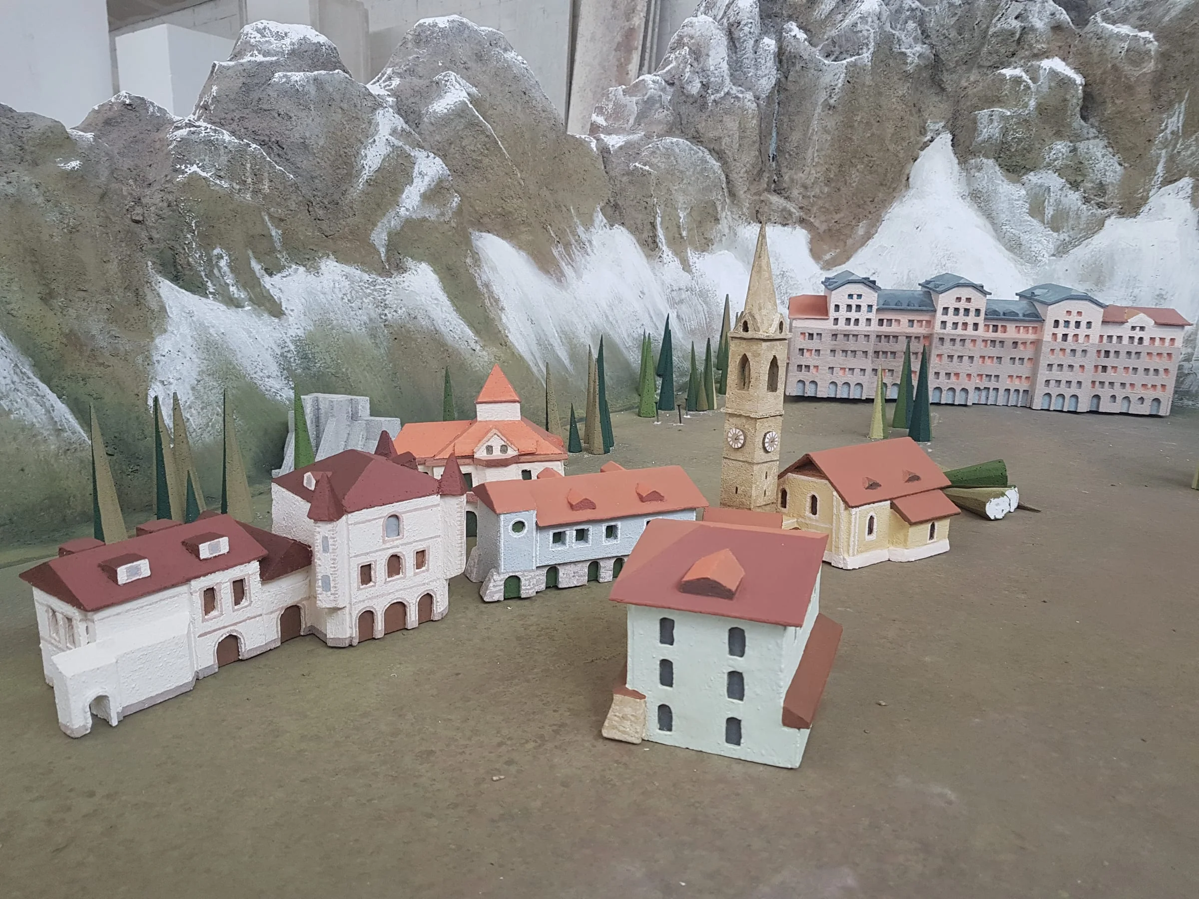 Detail of the houses painted one by one with the palette of reds, yellows and creams chosen by the production designer