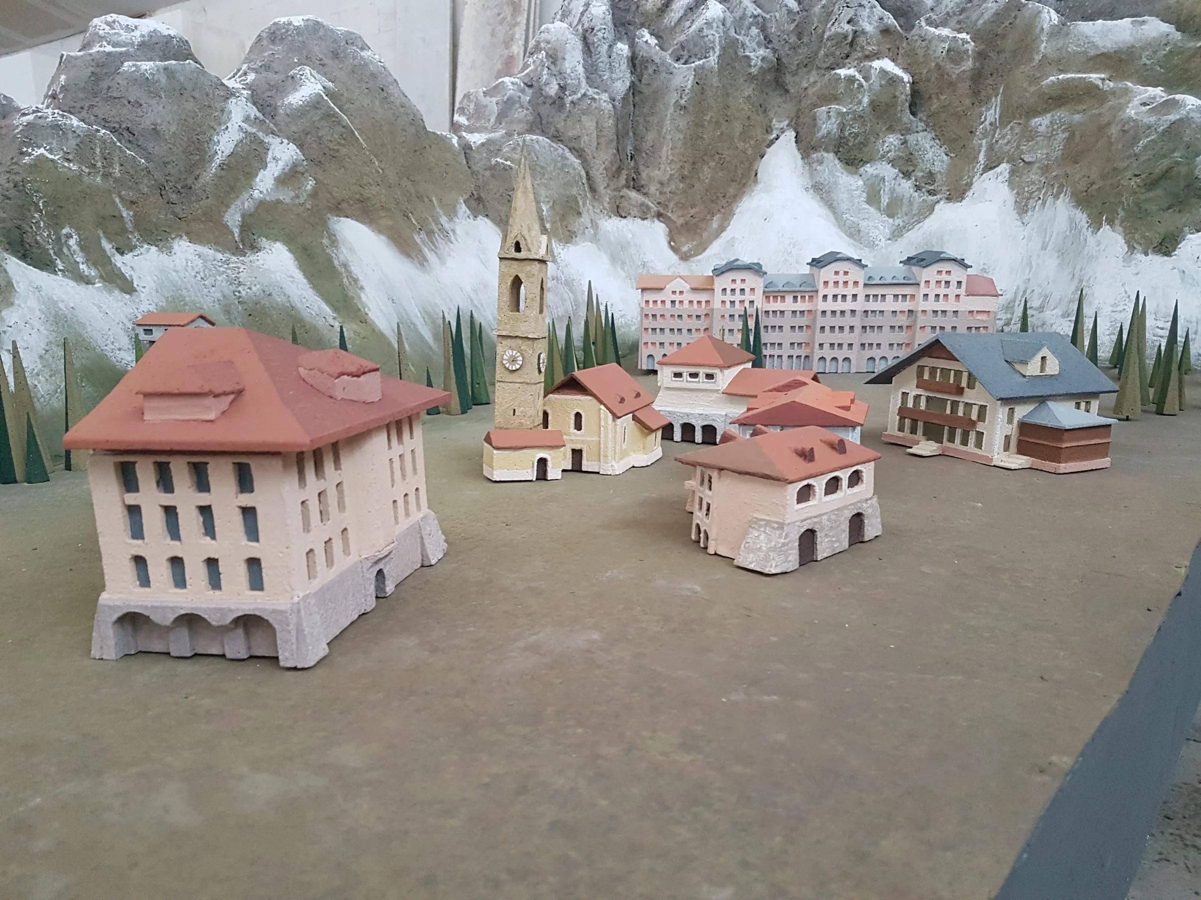 Detail of the model: the central square with Gothic bell tower, fountain, houses with red roofs