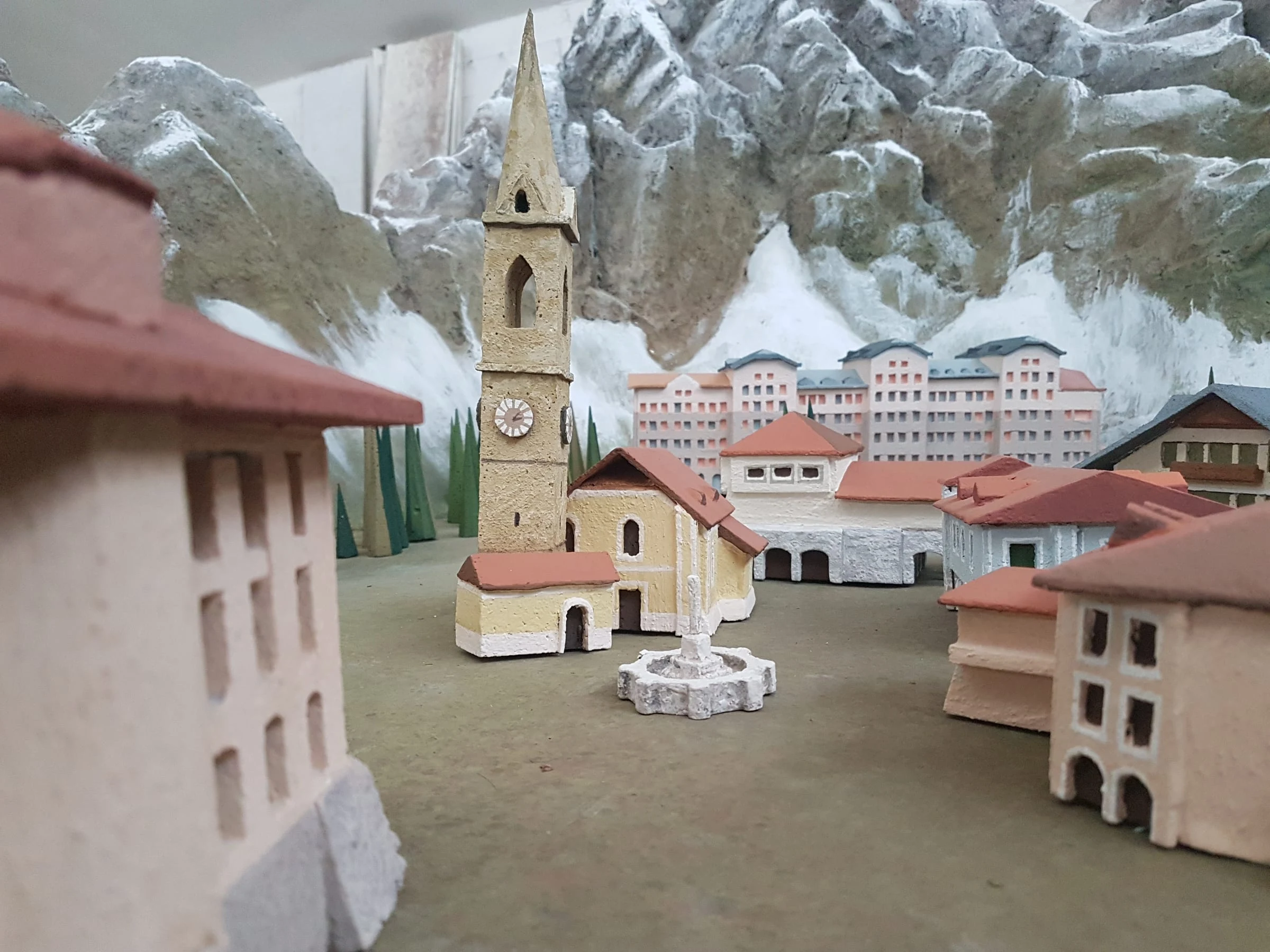 Overall view of the finished model: the village of Avechot tucked between snow-capped mountains, Gothic bell tower at the centre, sculpted firs