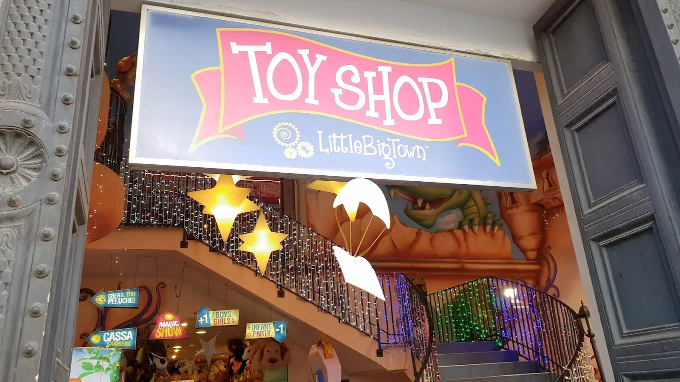 External sign of the Little Big Town megastore in Rome near Piazza Venezia: windows and entrance of the multi-floor store, logo lettering high on the historic facade of the building that housed the shop