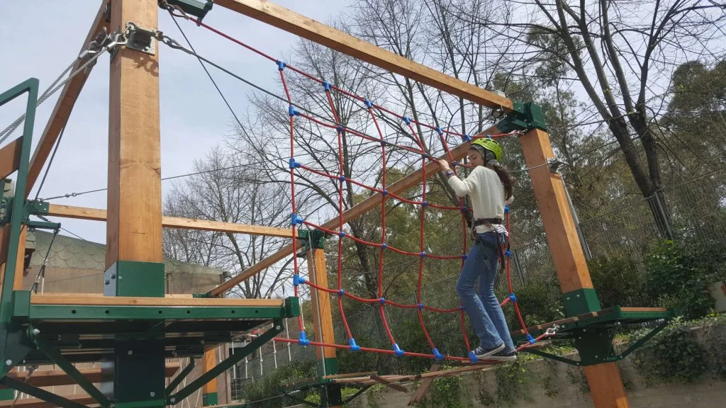 The 'Il Bosco di Maia' attraction at Luneur Park: forest-themed natural scenography with trees, giant flowers and forest animals