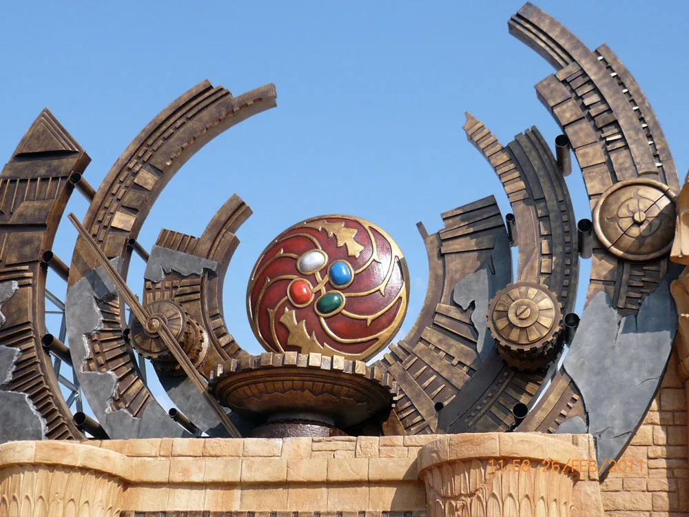 Huntik's entrance gate photographed on 25 February 2011: large red amulet with four coloured gemstones at the centre, metal semicircles with mechanical details