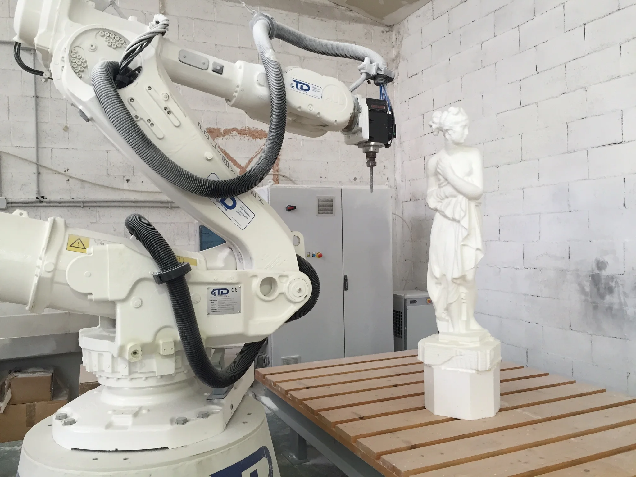 Detail of the CNC robotic arm milling, rotating cutter on the polystyrene block surface